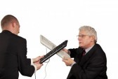 8860335-two-angry-businessmen-hitting-each-other-with-keyboards